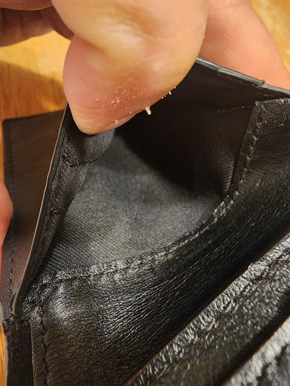 black Coach 3-in-1 wallet featuring the brand's iconic debossed signature pebble